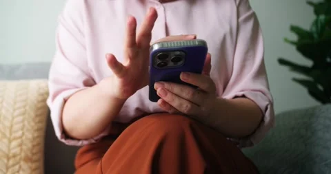 A woman's hand is using text messages on a mobile phone or chatting. Close-up of Stock Footage 285815107