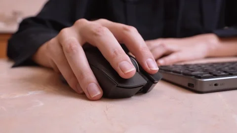 Woman's hand using a wireless computer mouse Stock Footage 327663915