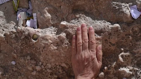 Woman's hand on Wailing Wall with notes of paper Stock-Footage 183990621