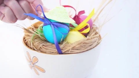 Woman's Hand Wearing a Straw Hat on the Egg Video stock 73604472