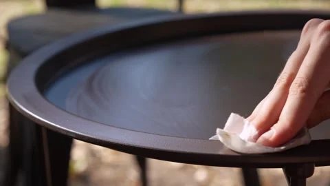 A woman's hand wipes the coffee table clean of dirt. Close-up Stock Footage 279681937