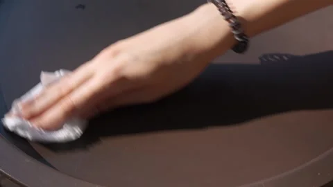 A woman's hand wipes the coffee table clean of dirt Stock Footage 281342905