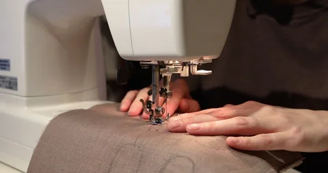A woman's hand working on a sewing machine close up. Workshop in sewing fabric. Stock-Footage 101835139
