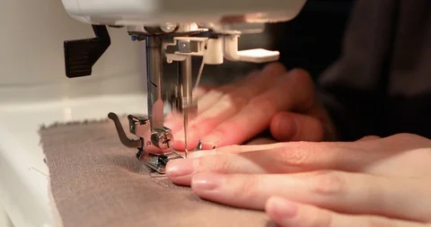 A woman's hand working on a sewing machine close up. Workshop in sewing fabric. Stock-Footage 101835193