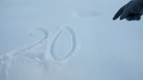 Woman's hand writes 2018 sign on the white snow Video stock 86510854