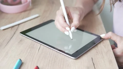 The woman's hand writes on the screen of the tablet STOP in large letters Stock Footage 134637004
