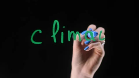 A woman's hand writes words about climate on a transparent board. climate Stock Footage 166768548