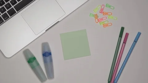 Womans hand writing COLLEGE on notepad. Laptop and stationery on the table. Stock Footage 101962241