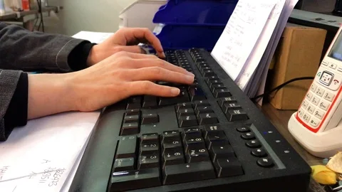 Woman's hand writing on a keyboard in the office Stock Footage 106720751