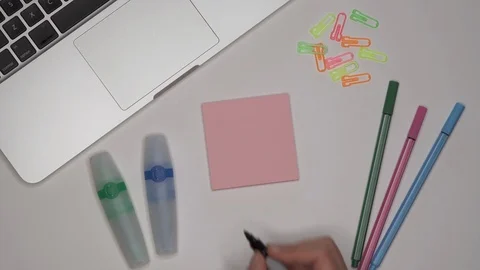 Womans hand writing LESSON 1 on notepad Stock Footage 100113689