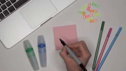 Womans hand writing LESSON 3 on notepad Stock Footage 100113771