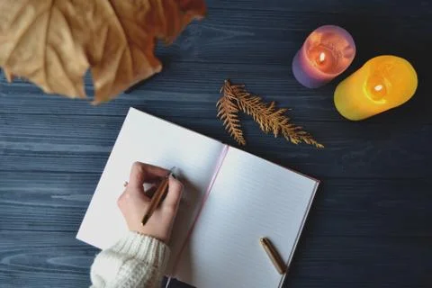Woman's hand writing in the notebook. Stock Photos
