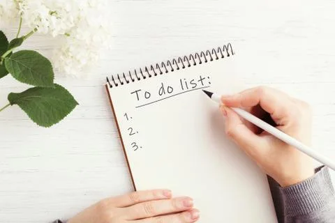 Woman's hand writing in notebook. Stock Photos