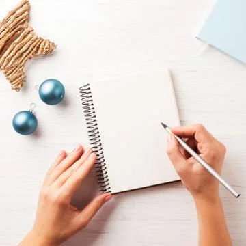 Woman's hand writing in notebook. Stock Photos