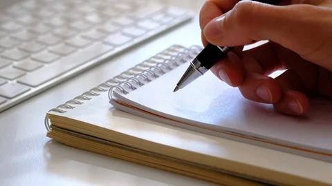 Woman's hand writing a plan Stock Footage 93241185