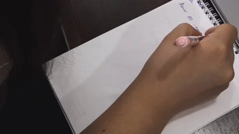 A woman's hand is writing something in a notebook. Stock Footage 157056905