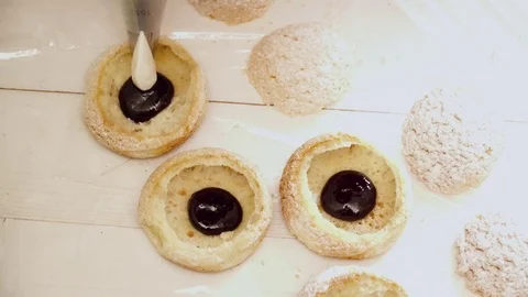 Woman's hands adding the chokolate to the eclair closeup Stock Footage 74477726