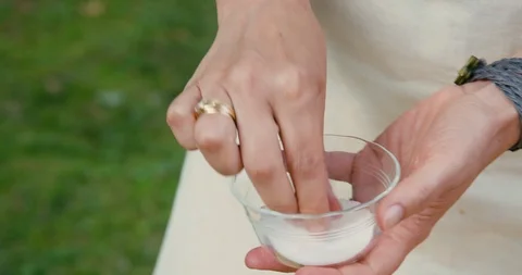 Woman's hands adding salt to Tabbouleh salad Stock Footage 119846796