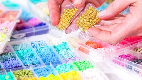 Woman's Hands Amidst a Rainbow Array of Beads for Jewelry Crafting Stock Photos