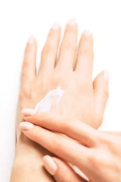 Womans hands applying moisturizing cream. Stock Photos