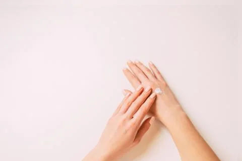 Womans hands applying moisturizing cream, copy-space. Stock Photos