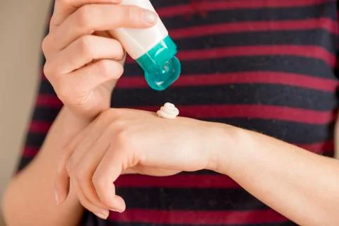 Woman's hands applying moisturizing hand-cream on Stock Photos