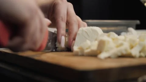 Woman's hands are cutting the mozzarella cheese Stock Footage 273234520