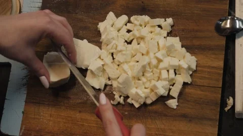 Woman's hands are cutting the mozzarella cheese Video stock 273234663