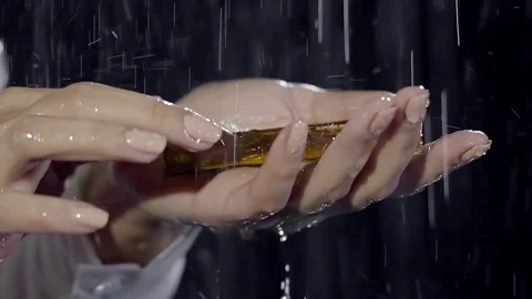 Woman's hands are holding a flacon of parfume. Video stock 80999971