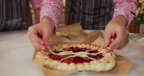 Woman,s hands are making round sweet pie with jam at home on the kitchen. Stock Footage 231336706