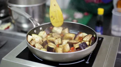 Woman's hands are mixing vegetable ragout stewing in the pan Stock Footage 64974376