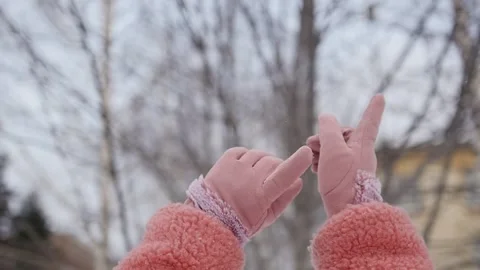 The woman's hands are raised up. Hands in pink gloves on the background of Stock Footage 148956834