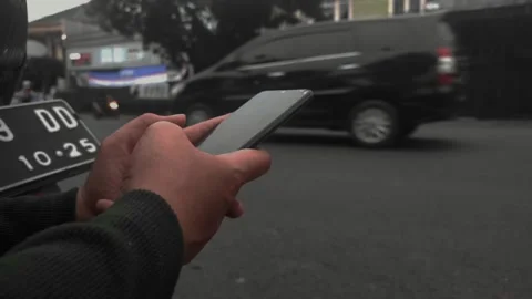 Woman's Hands Are Scrolling Cell Phones On The Edge Of The Highway Stock Footage 232363513
