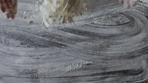 Woman's hands are throwing natural flour on a kitchen table. Splash from flour Video stock 131440653