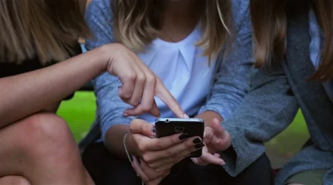 Woman's hands are using smartphone. Park background Stock Footage 67785876
