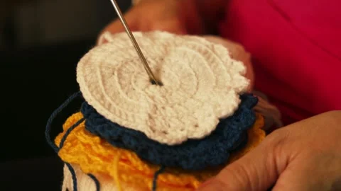 Woman's hands arranging layered crochet circles. Stock Footage 345514665