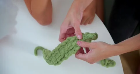 Womans hands assisting with knitting a soft craft project Stock Footage 288563485