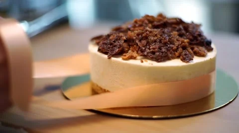 Woman's hands is bow ties on the cake Stock Footage 56480099