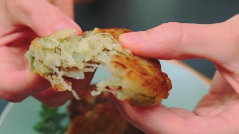 Woman's Hands Breaking Fried Vegetable Cutlet Indoors 库存影片 342889617