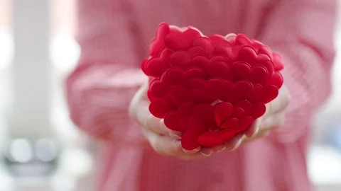 Woman's hands breaking red heart into two parts Stock Footage 71612411