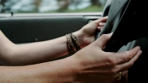 Woman's hands on a car wheel while driving Stock Footage 76317914