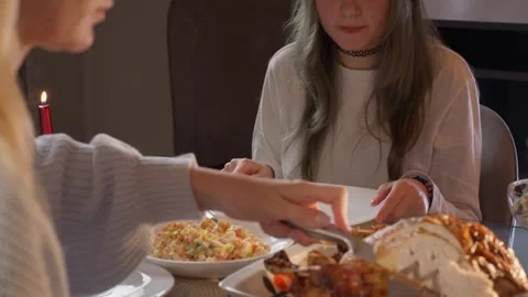 Woman's hands carefully carving a slice of roasted turkey and placing it on.. Stock Footage 343682074