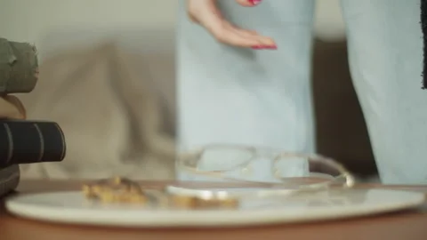 Woman's hands carefully examining an open Bible with reading glasses nearby Stock Footage 319977938