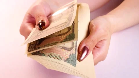 A woman's hands checking 10,000 yen bills Stock Footage 318377501