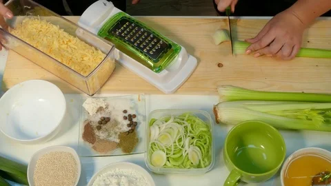 Woman's hands chop the celery and shift the cheese into a plate Stock Footage 78488438