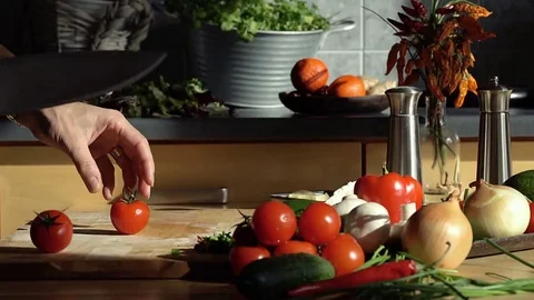 Woman's hands chopping red tomatoes, steadycam Stock Footage 73986521
