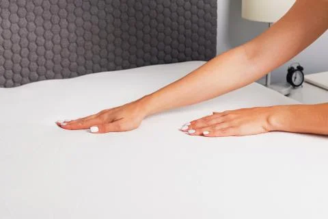 Woman's hands close-up making the bed. Stock Photos