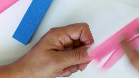 Woman's hands close-up. Manicure, nail file on white background, home manicure Stock Footage 271252863