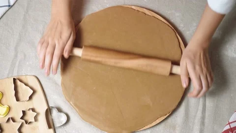 Woman's hands close-up roll out dough for gingerbread with a wooden rolling pin Stock Footage 142634719