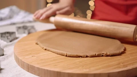 Woman's hands close-up roll out dough for gingerbread with a wooden rolling pin Stock Footage 143711721